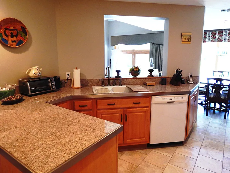 custom cabinets, porcelain floor through kitchen & dining room, granite countertops