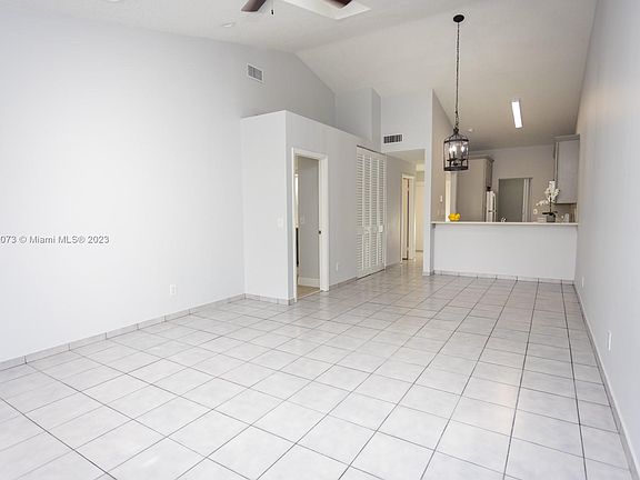 Living/dining with vaulted ceiling & skylights