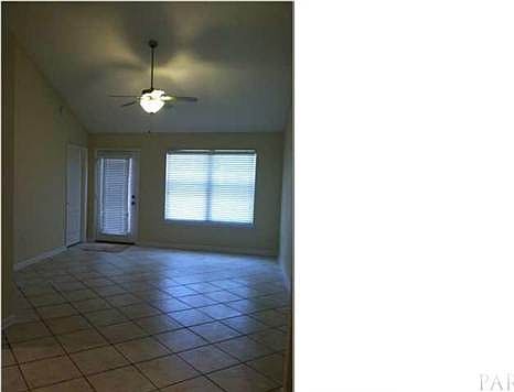 Tiled living area with vaulted ceilings.