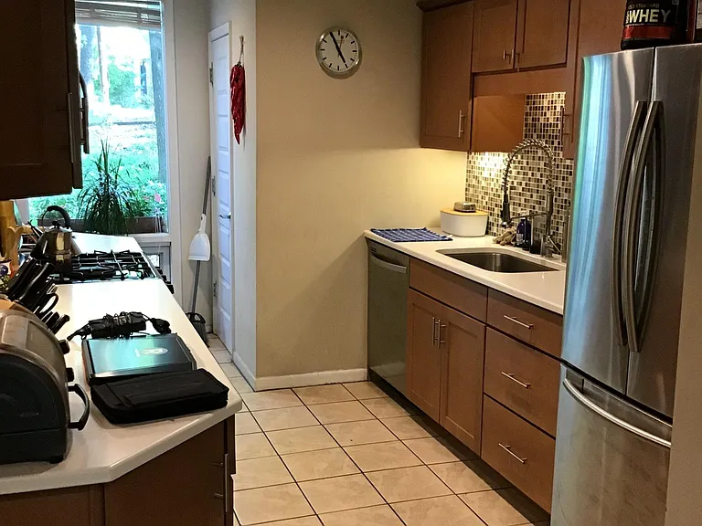 Chefs kitchen, high-end gas range, microwave, commercial style sink with granite counters, stainless steel appliances and dishwasher, ceramic tile floor.