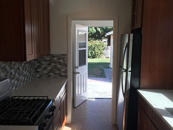 Service porch leads to backyard