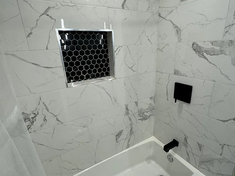 Guest bath with shower and tub, niche.