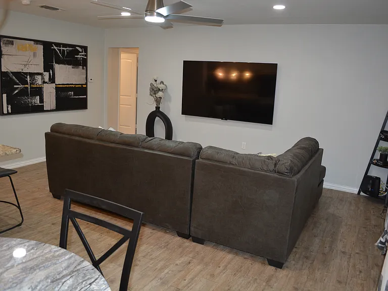 Unwind in a spacious, open-concept living room featuring plenty of comfortable seating meaning there is room for everyone to relax and make lasting memories together.