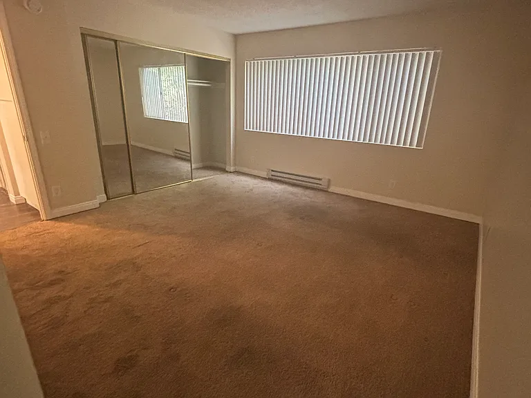 Bedroom with mirrored closet doors