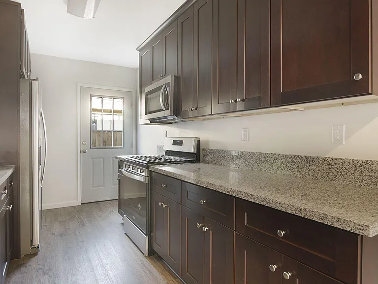 remodeled kitchen with stainless steel stove and refrigerator
