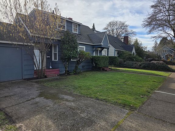 Front of home (faces W. 11th) and shared driveway. 'To the far left is the storage unit.