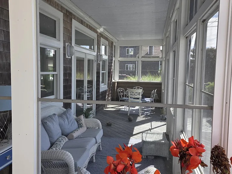 Screen porch with sitting and dining areas