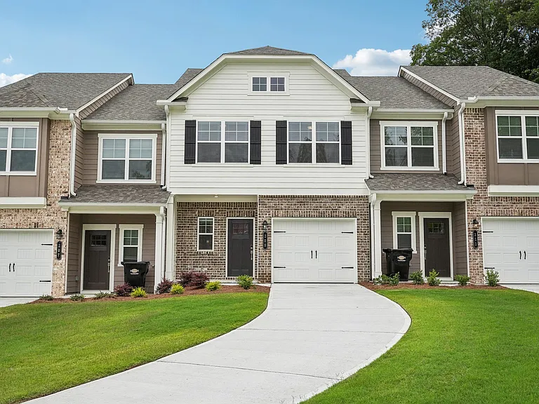 Exterior of the Monterey floorplan, two story townhome with a private driveway and attached garage.