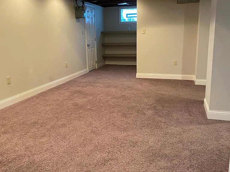 Finished basement with built in shelving
