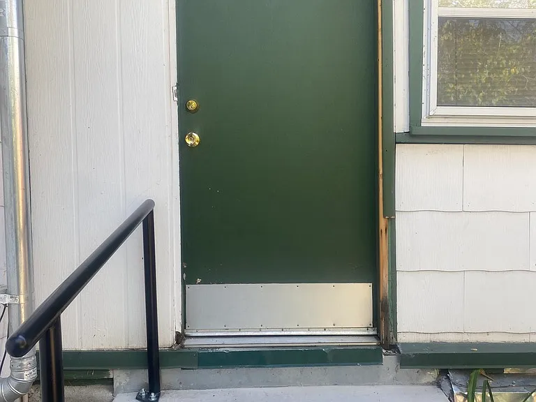 Back entrance is a keyless code with a railing.