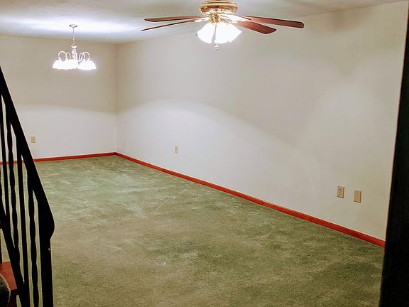 Large family room with laundry room and bath, nice window at one end.