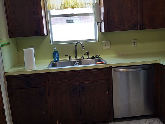 Kitchen with dishwasher, electric stove, fridge, small pantry