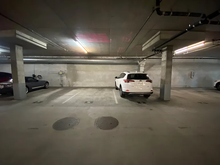 2 large covered unground secure side by side parking spaces