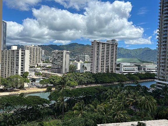 View from the patio of the unit. Ala Wai Canal, Hawaii Convention Center and Manoa Valley in picture.