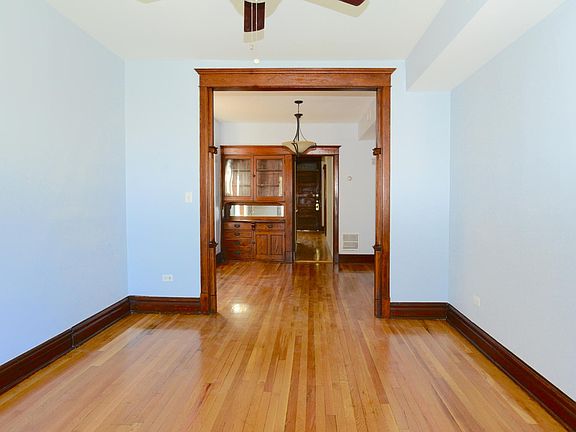 Beautiful carved woodwork arch leads from living room to din