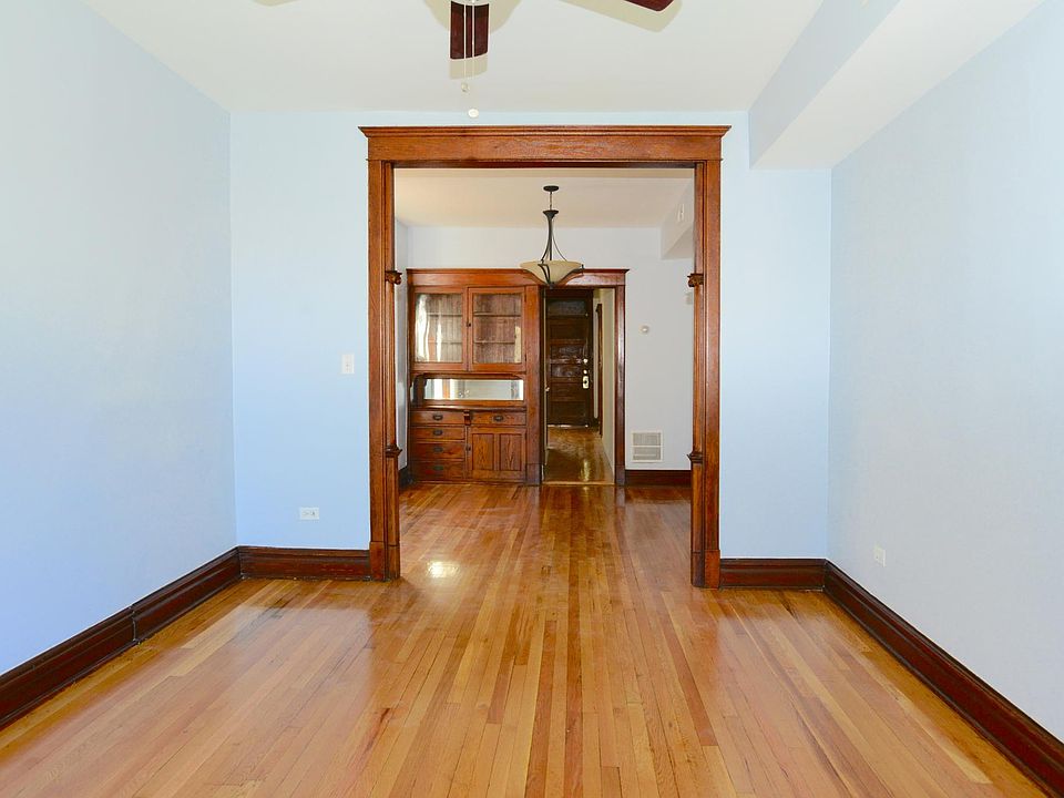 Beautiful carved woodwork arch leads from living room to din