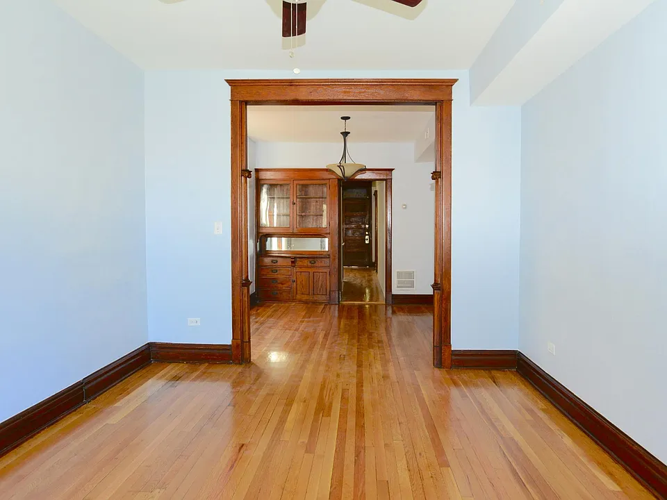 Beautiful carved woodwork arch leads from living room to din