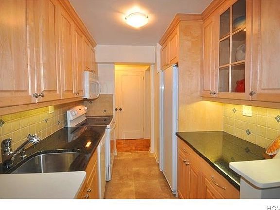 New kitchen has granite counters, tile back splash, plenty of storage cabinets and appliances include a dishwasher, microwave, range and side by side refrigerator.