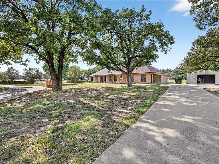 Party parking with a Circular Drive to the front entrance of the house. and a long driveway up to the Garage and the 24x32 Shop building.