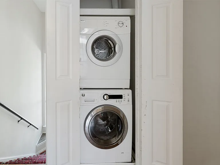 Stacked washer and dryer units within a dedicated closet