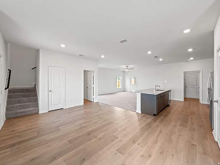 The open-concept layout of this floor plan has the kitchen, family room and dining room sitting next to one another.