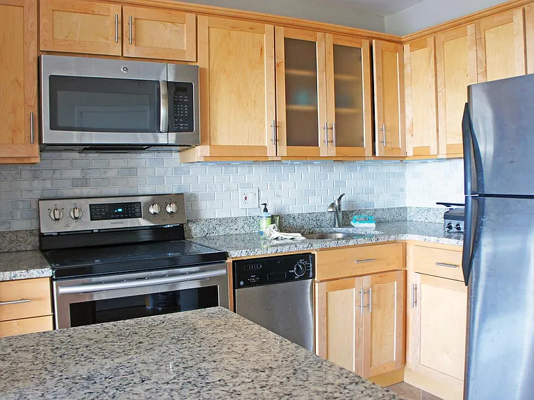 Marble backsplash, granite counters, and stainless steel appliances - there's even a dishwasher!