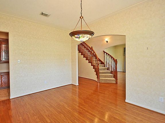 Formal Dining (12x16).   Wood floors. Large and open  it will make entertaining a breeze.   On the left side, note the custom built-in lighted cabinets.