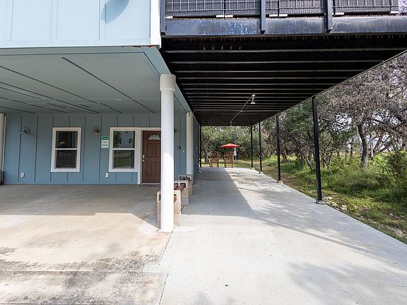 View of lower unit and covered parking area
