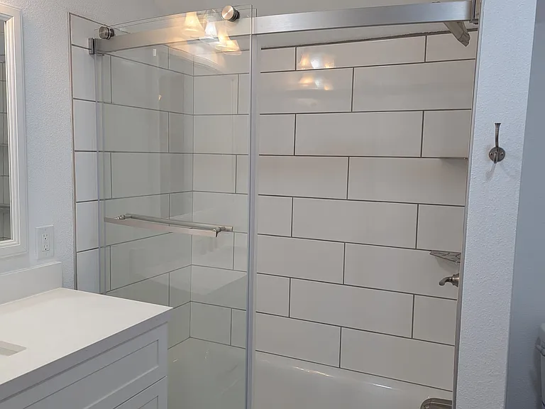 Full sized tub, with glass sliding shower slides, tub has the bump out to enjoy every inch of space available.