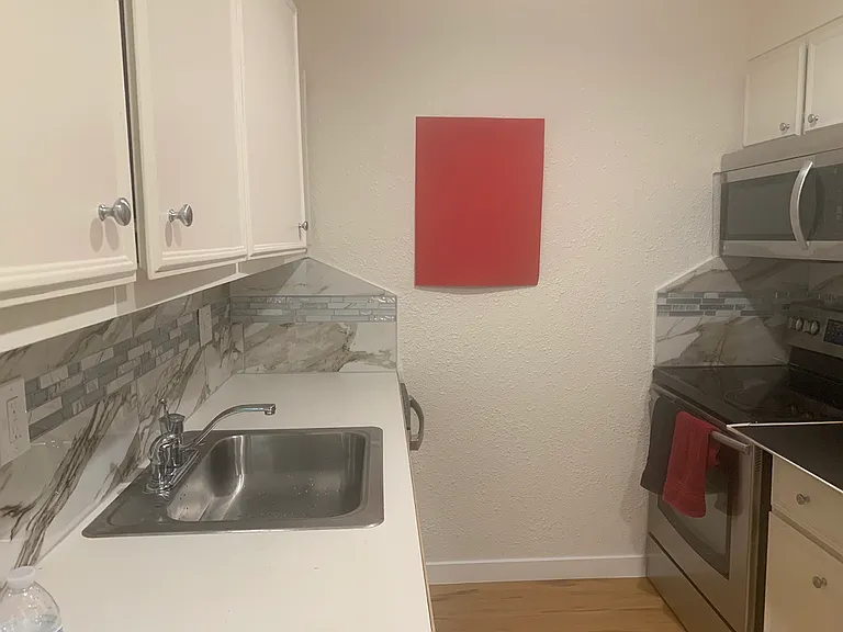 kitchen with tiling, stainless steel appliances and new electric box