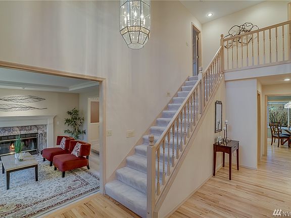 Dramatic soaring entrance with newly refinished hardwood floors.