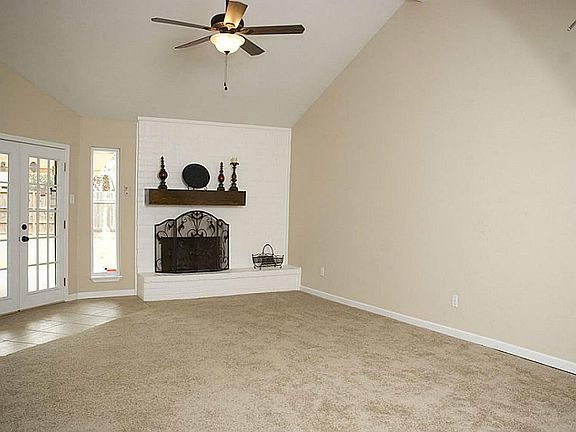 The room also has a vaulted ceiling and a charming mock fireplace.