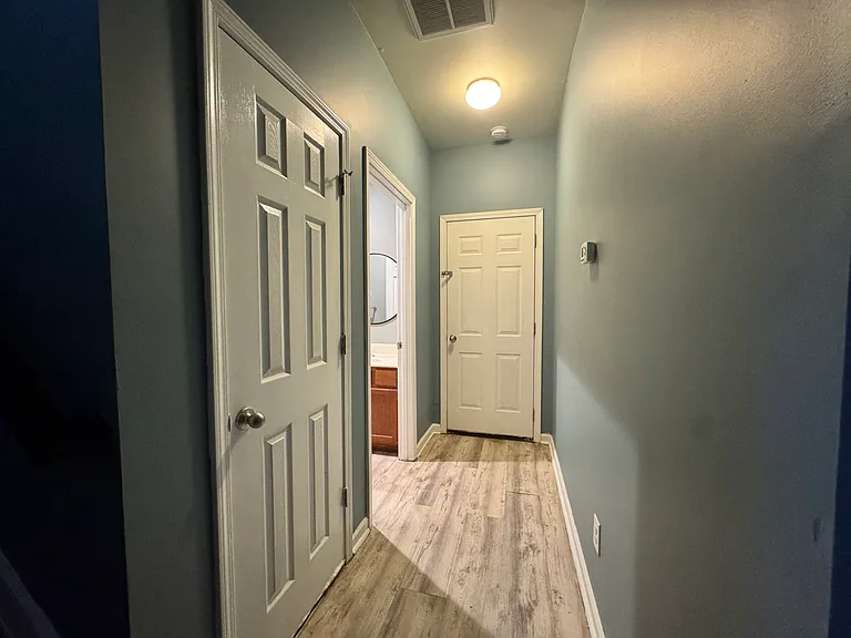 Step outside the bedrooms and you'll find a large walk-in closet with lighting, a clean bathroom, and access to the spacious basement, all just to the left of the staircase.