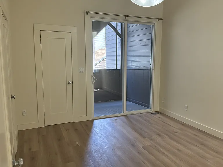 Second bedroom with sliding door access to rear porch.
