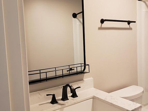 New, clean, functional bathroom with full size bath tub and shower.