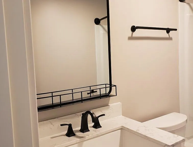 New, clean, functional bathroom with full size bath tub and shower.