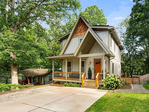 Front of the house with gravel walking path to the gated backyard.