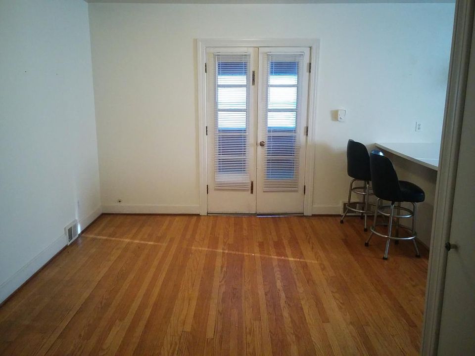 kitchen opens to dining room with hardwood floors