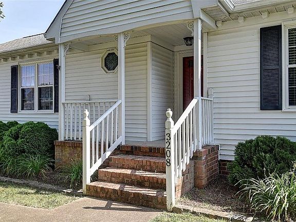 Nice Porch for relaxing after work with handsome landscaping framing the porch