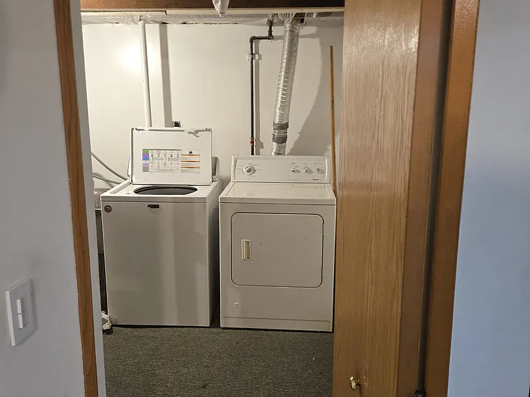 entrance to utility area where laundry machine and dryer are located