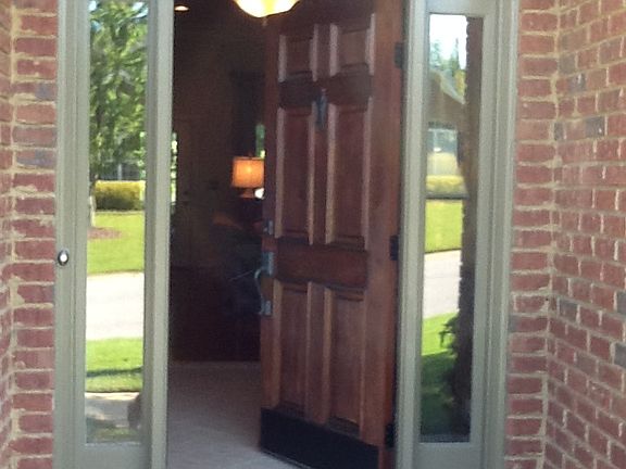 Stained wood door at entry