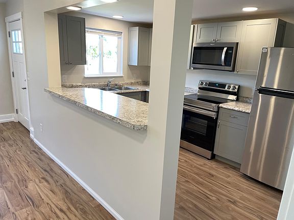 Laminated counters, new cabinets and appliances. Dishwasher next to the sink.