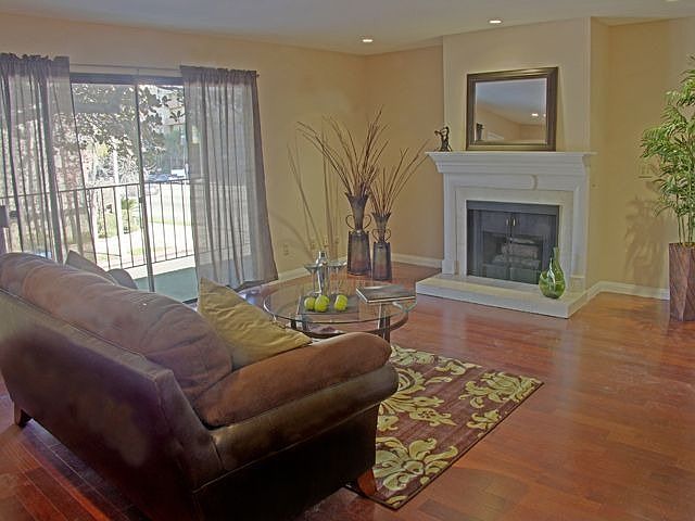 The living room has sliding glass doors that open out to a balcony.