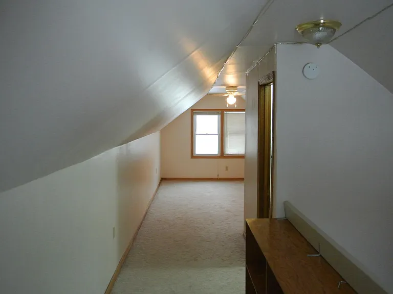 Stairway to the right, facing into the upstairs bedroom.