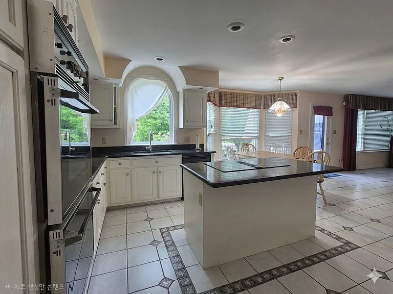 Gourmet Kitchen with granite counter tops, breakfast area and...... opens to family room and out to deck.