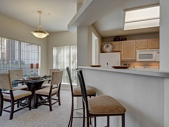 Beautiful Dining Area with Pendant Lighting and Large Windows