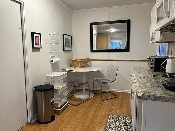 View of dining area and interior door to garage with the extra fridge and pantry space.