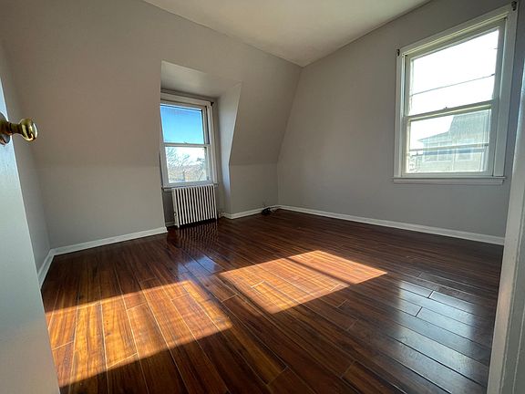 Comfortable master bedroom with hardwood floors and plenty of natural light, providing a peaceful retreat.