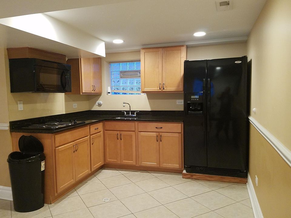 Kitchen with Refrigerator with electric top stove counter and microwave (no oven)