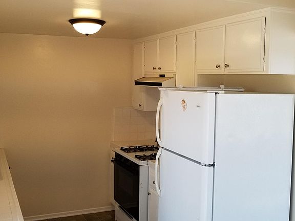 Kitchen with refrigerator. New stove will be purchased if te